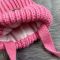 Зимова в'язана дитяча шапка рожева з двома натуральними бубонами KID BEWARM